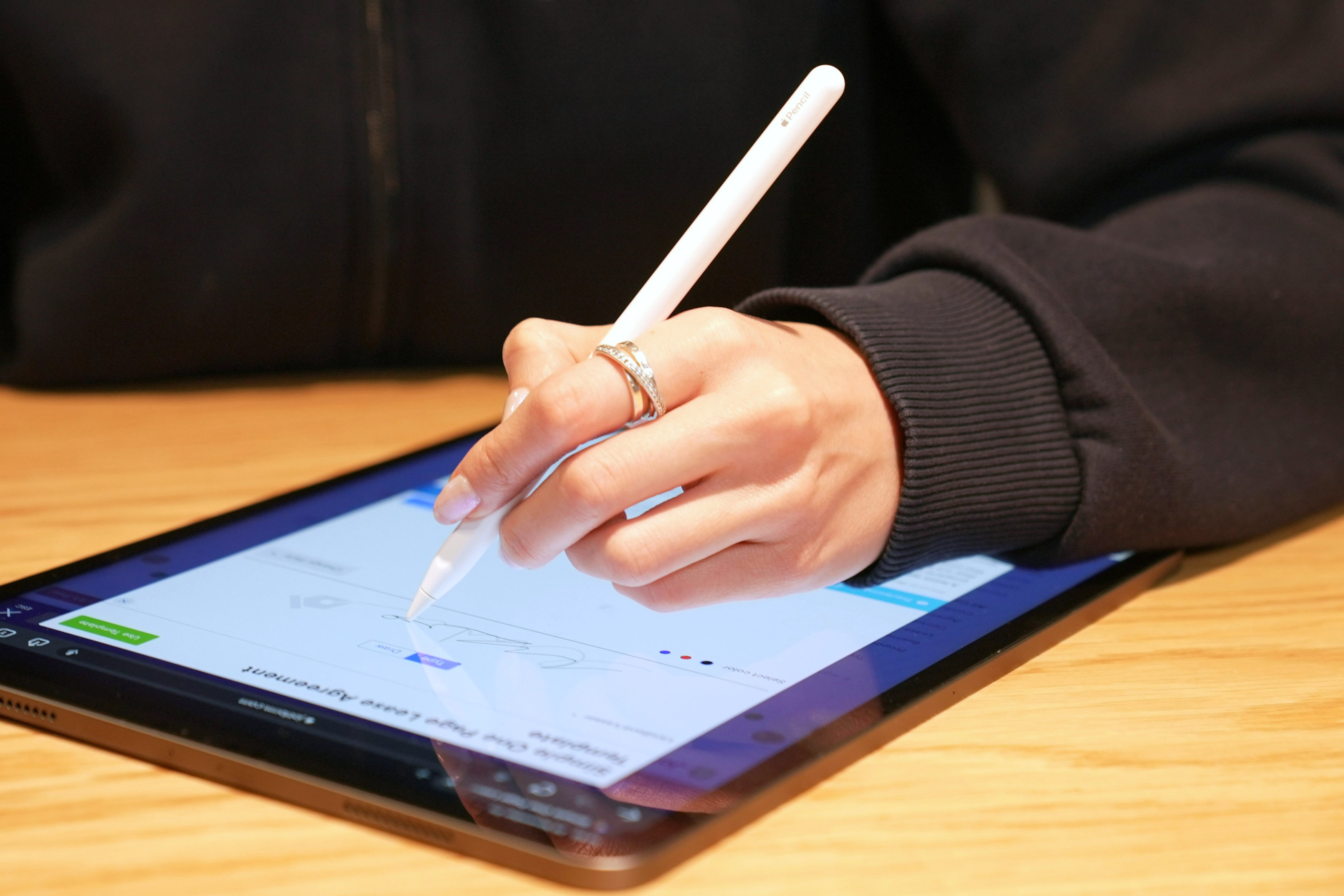 woman writing on a tablet