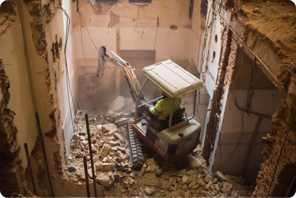 A mini excavator in the process of demolition