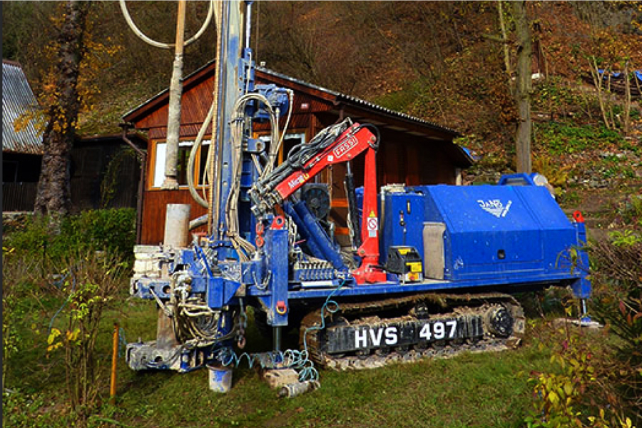 A large drilling machine drilling a well on a private property