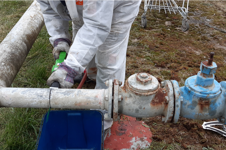 A man cleaning a pipe