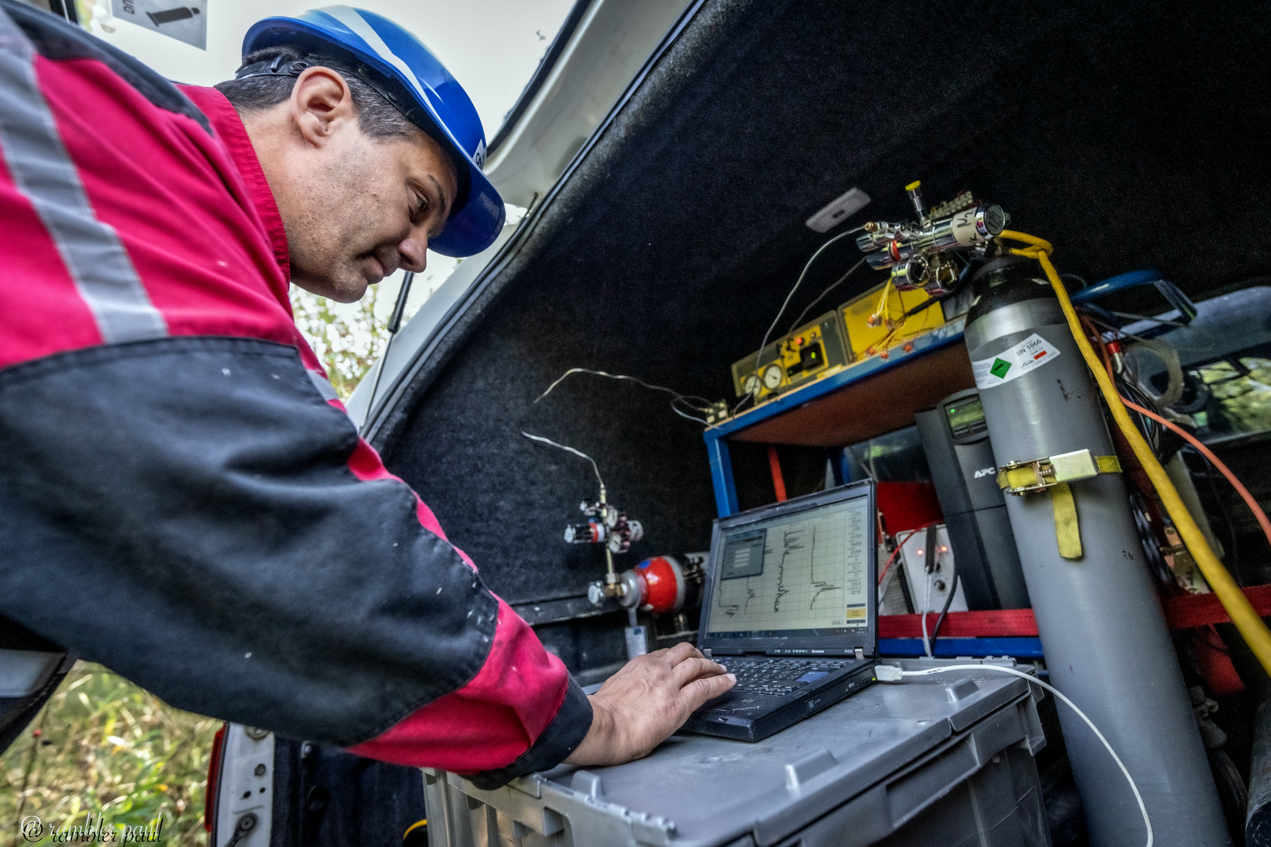 A man conducting measurements at a borehole