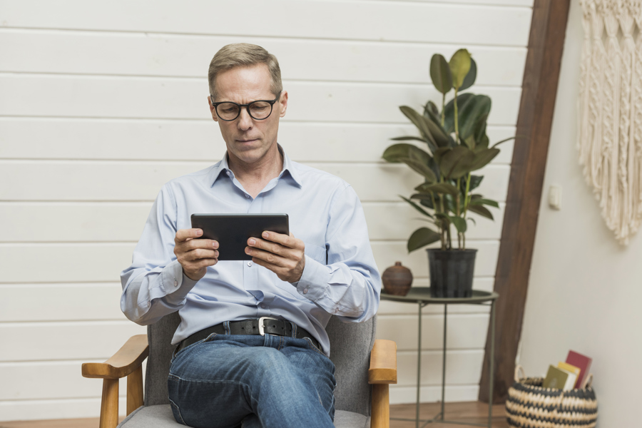 A man reading an article on a tablet