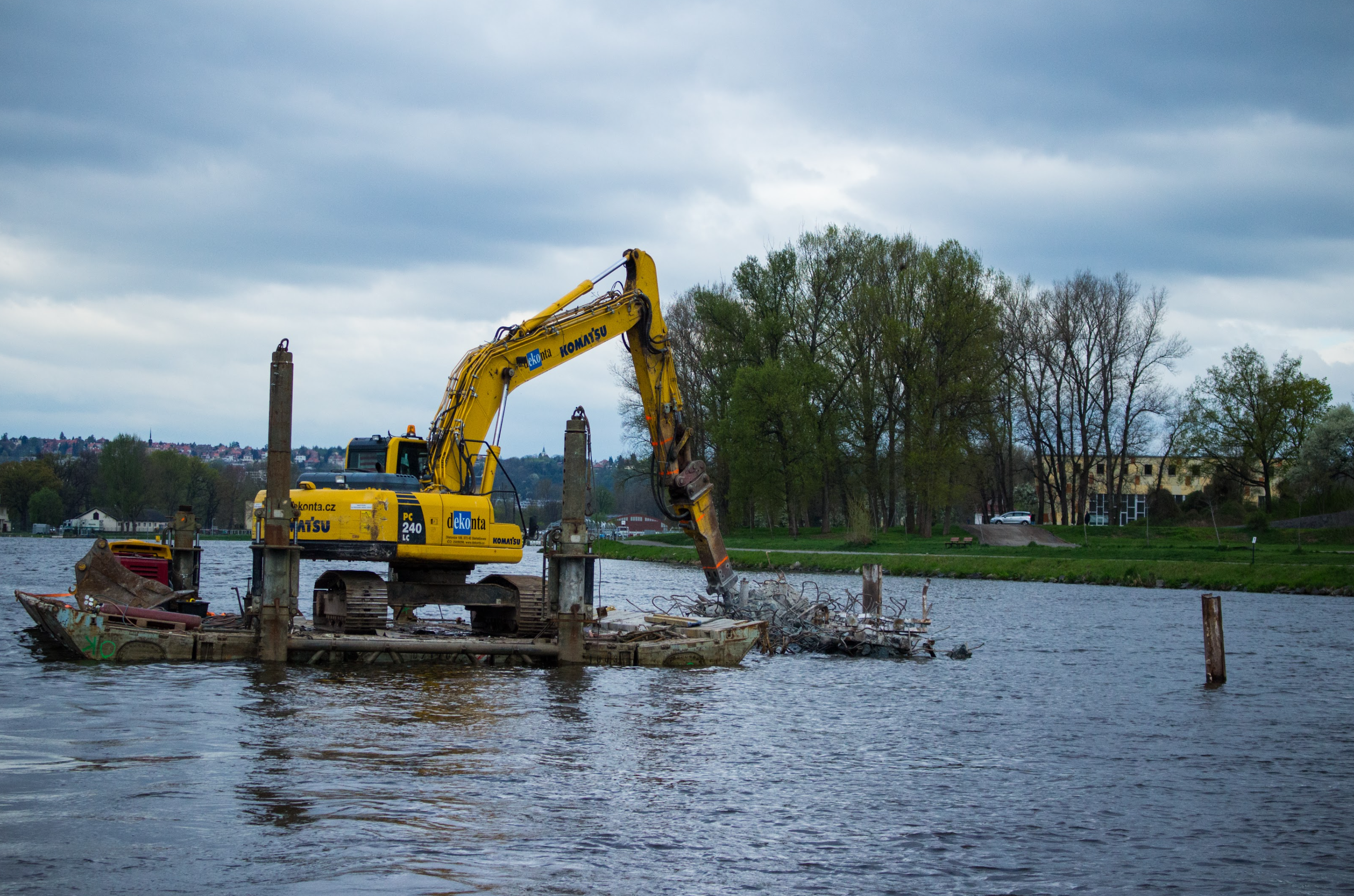 Heavy machinery performing demolition under water
